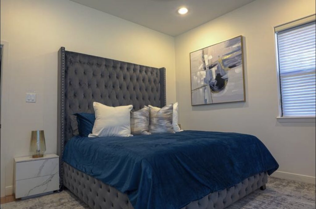 King bedroom with tufted headboard in Houston